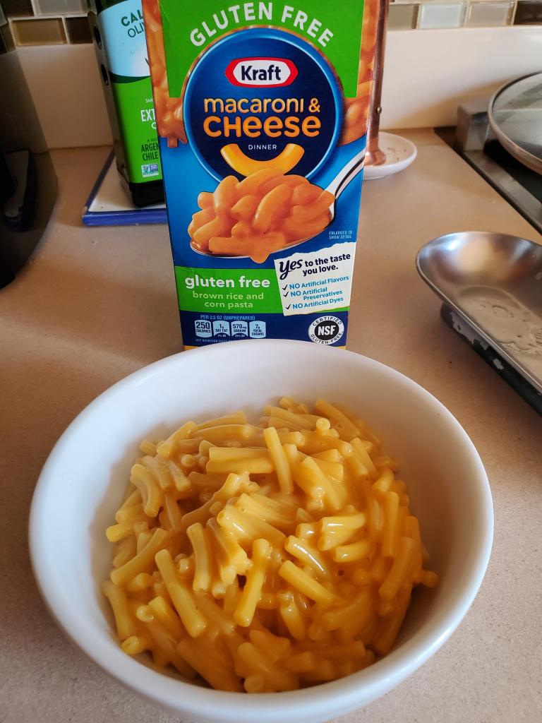 A bowl of Kraft Original Gluten Free Mac & Cheese next to its packaging